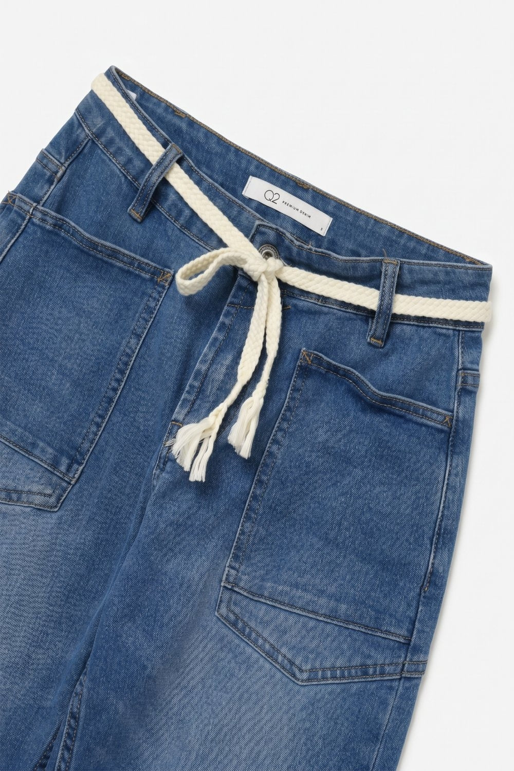 Jean bleu délavé moyen à jambes larges et ceinture.