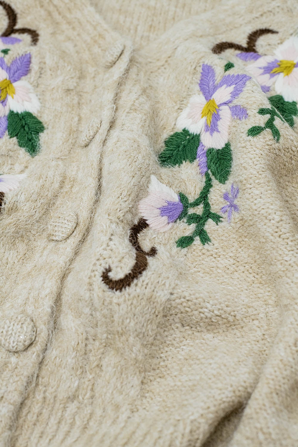 Cardigan beige en maille torsadée avec fleurs brodées