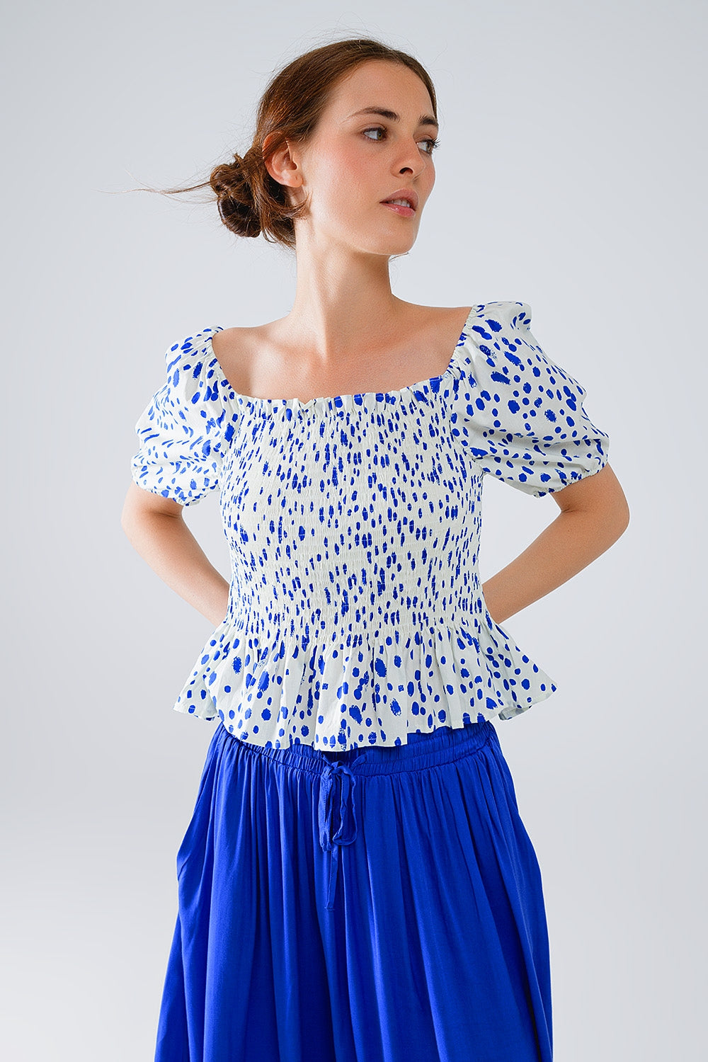 Chemisier blanc froncé à péplum et à pois bleus