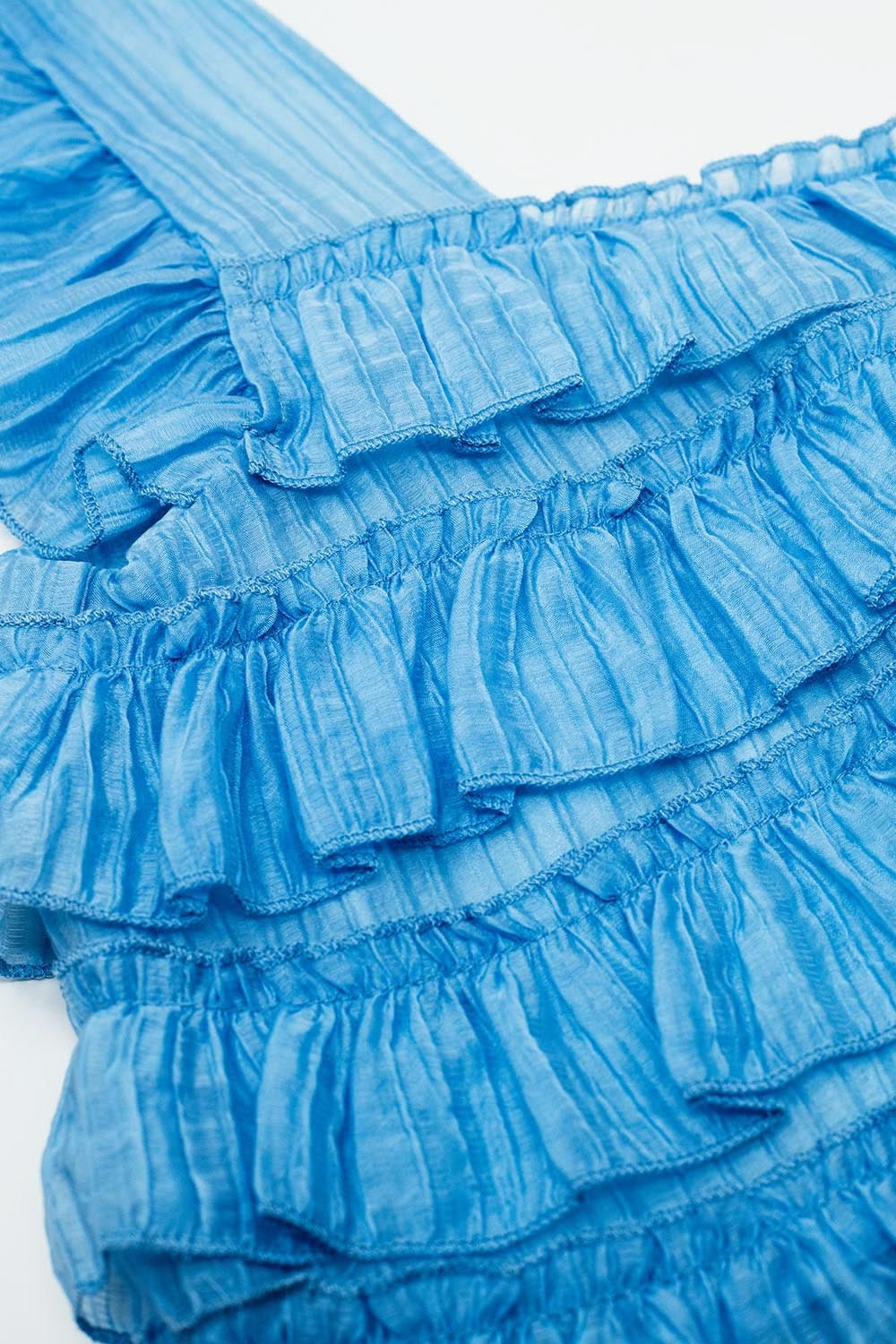 Haut bleu sans manches avec motif froncé
