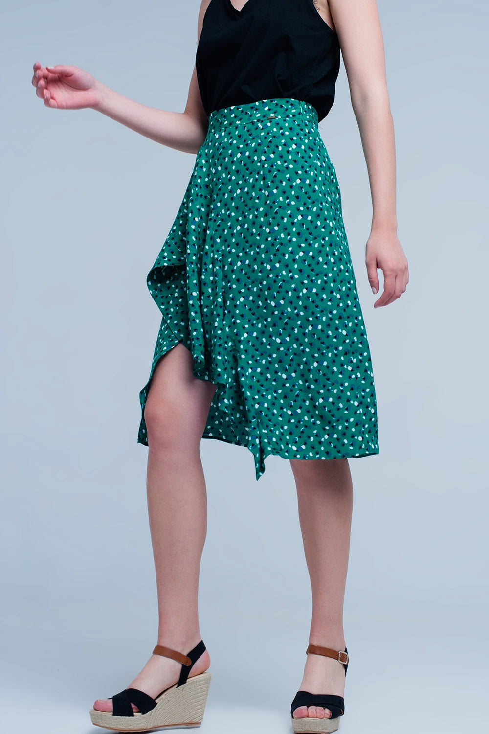 Jupe vert mi-longue avec volants et motif à pois