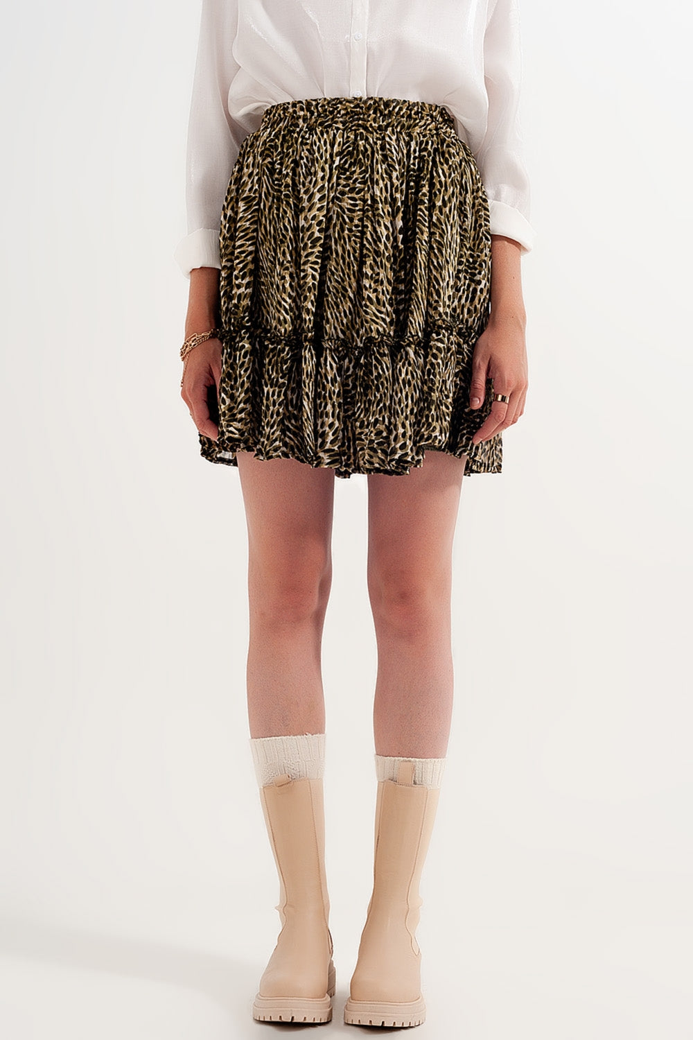 Mini-jupe en mousseline de soie verte avec taille élastique et tissu brillant