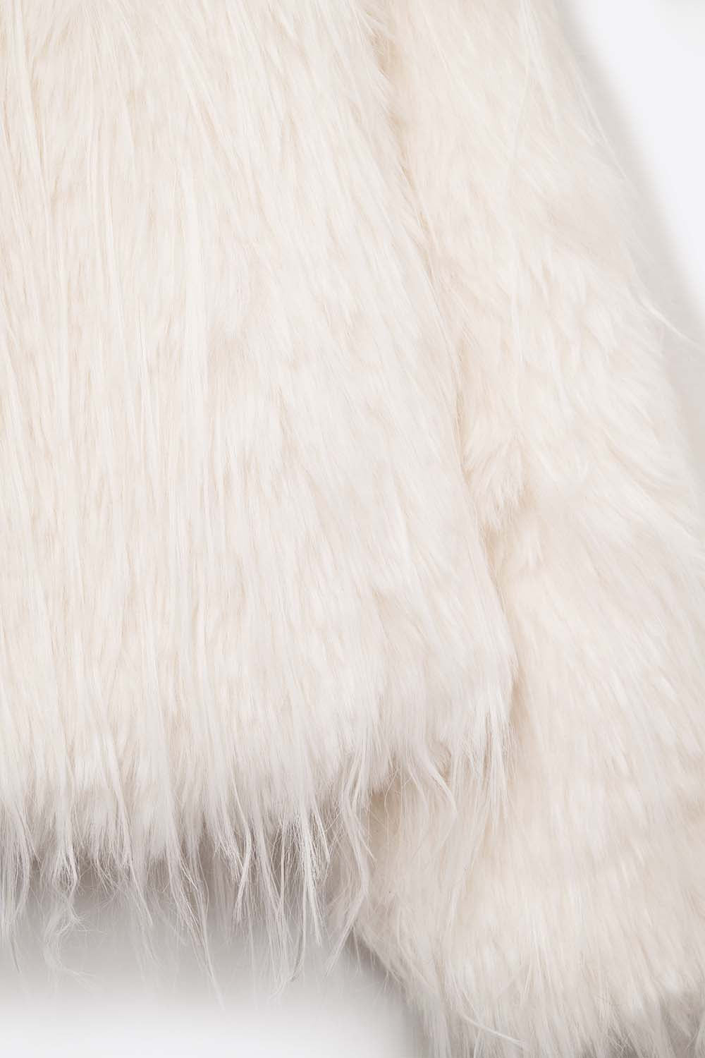 Veste sans col en fausse fourrure blanche