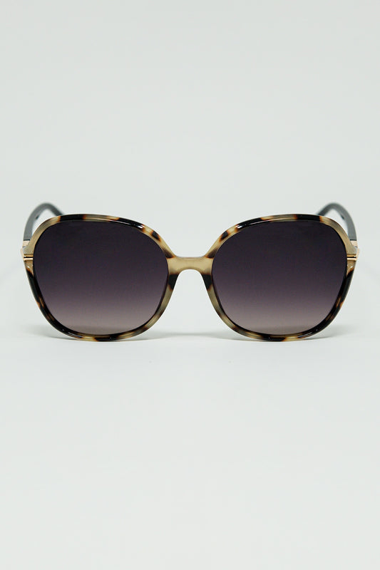 Lunettes de soleil rondes imprimées en beige avec détails en métal doré