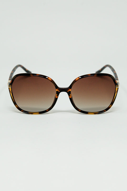 Lunettes de soleil rondes imprimées en beige avec détails en métal doré