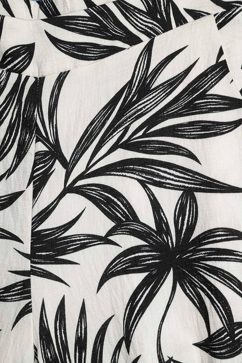 Pantalon à jambes larges en blanc avec détails floraux en noir