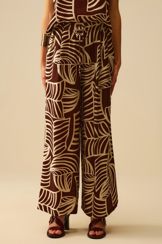 Pantalon large marron avec imprimé feuilles blanches