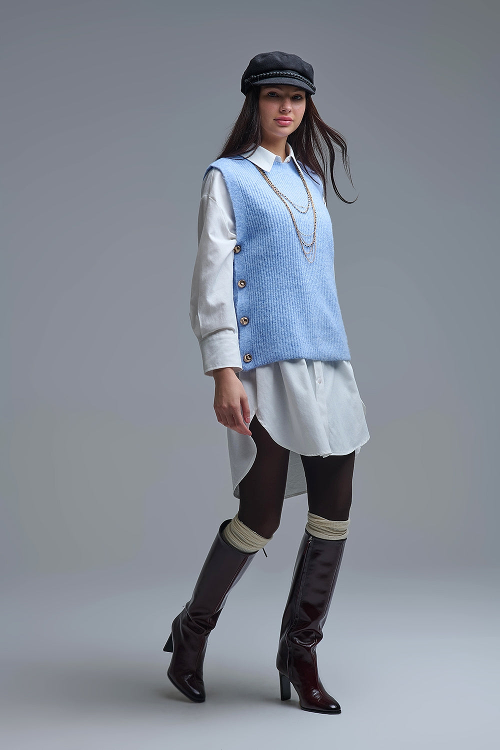 Pull bleu sans manches avec boutons dorés sur le côté