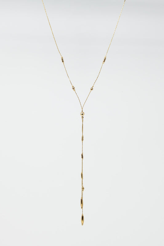 Long collier en or avec des perles en or et un long pompon en or