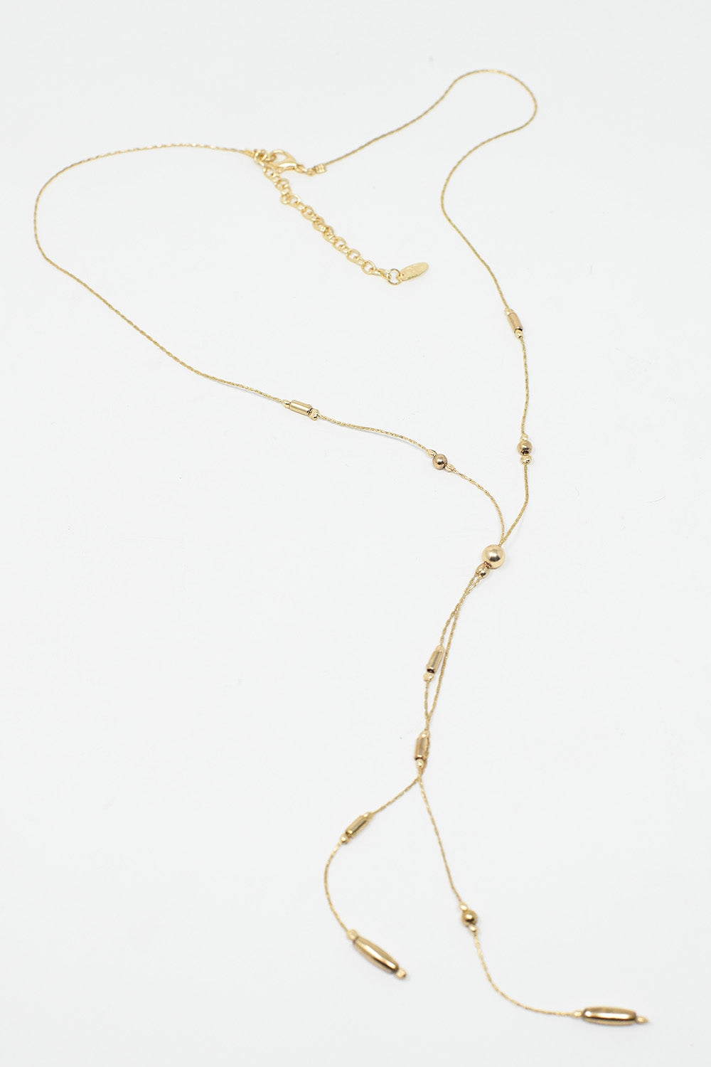 Long collier en or avec des perles en or et un long pompon en or