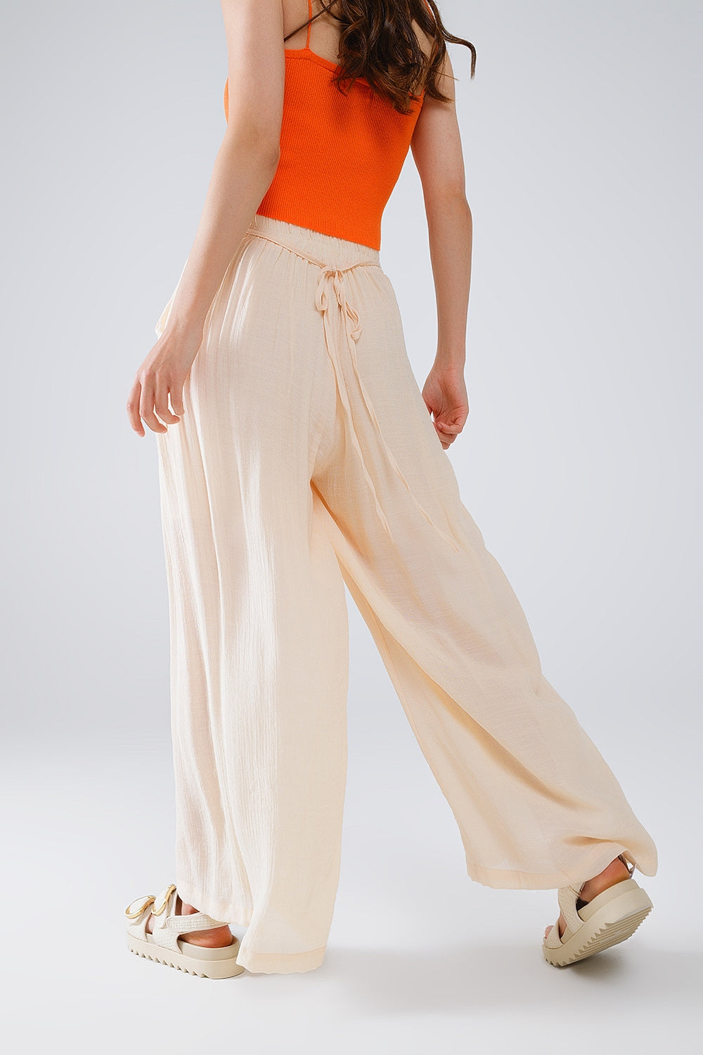 Pantalon de style palazzo beige avec poches latérales et bande de taille épaisse