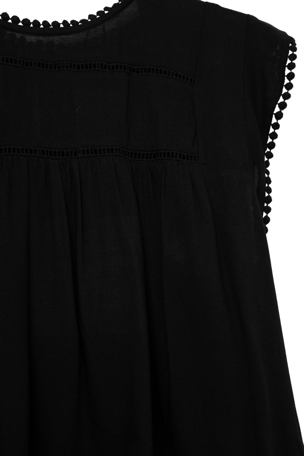 Chemise asymétrique noire avec détails Pom Pom