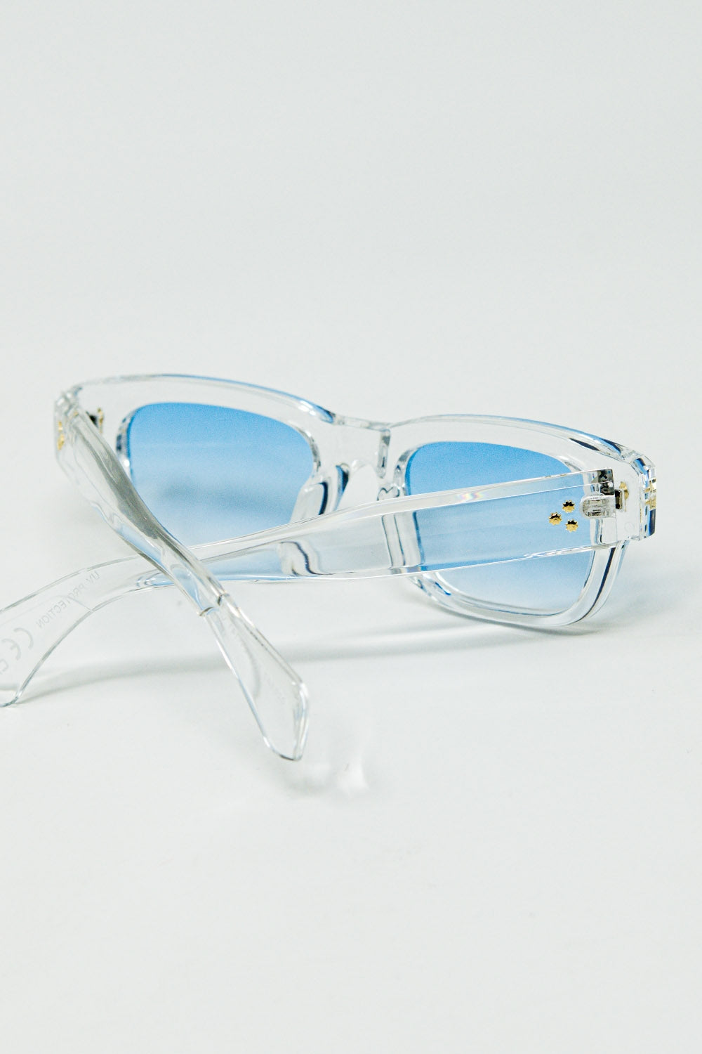 Lunettes de soleil blanches translucides avec verres ovales bleu clair