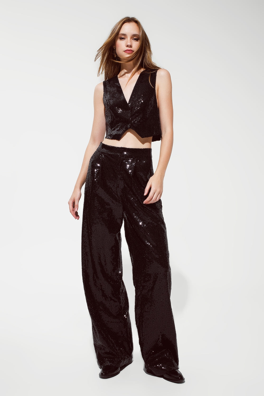 Pantalon noir à paillettes avec jambes évasées