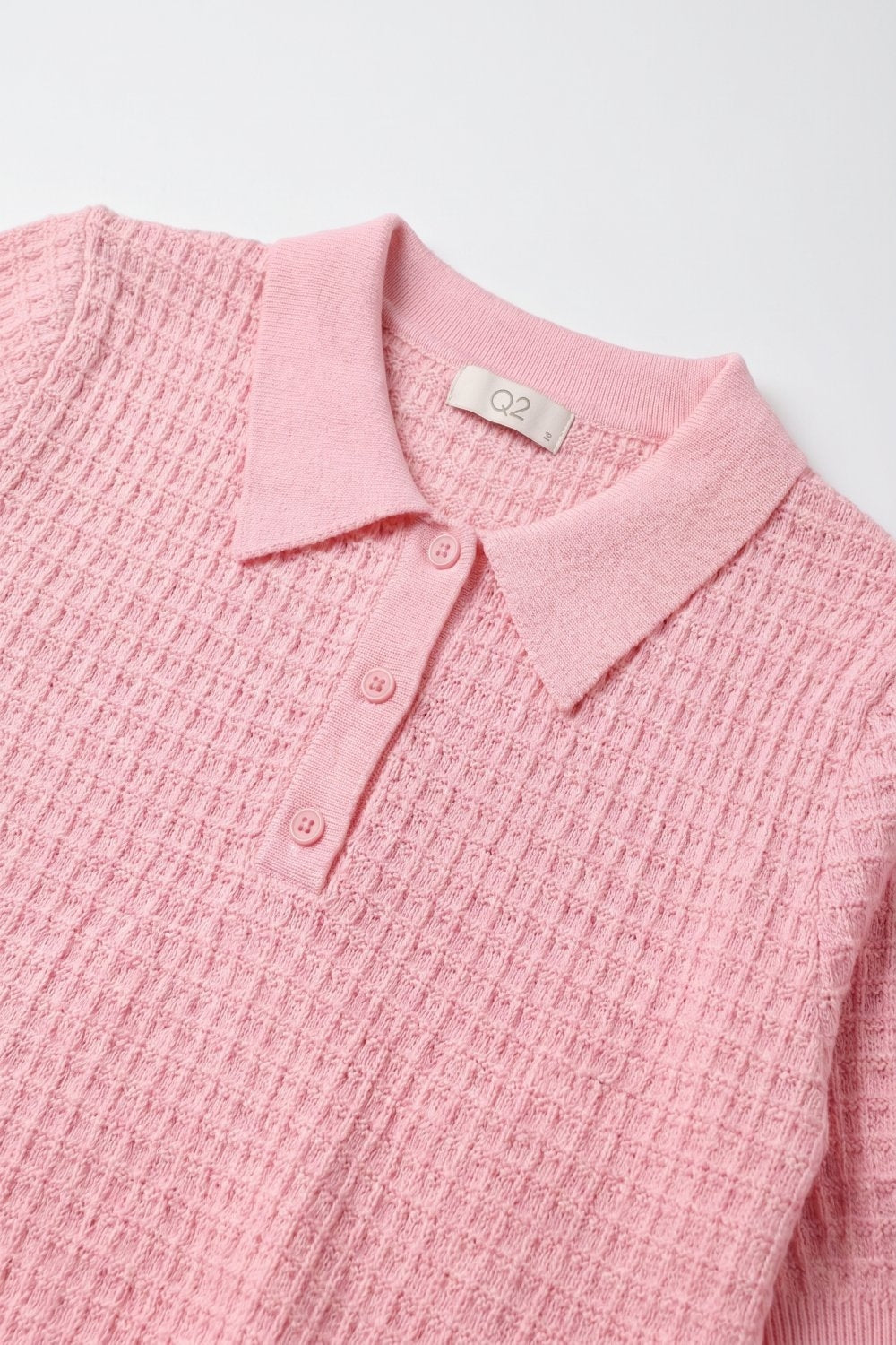 Polo boutonné en maille gaufrée rose à manches courtes