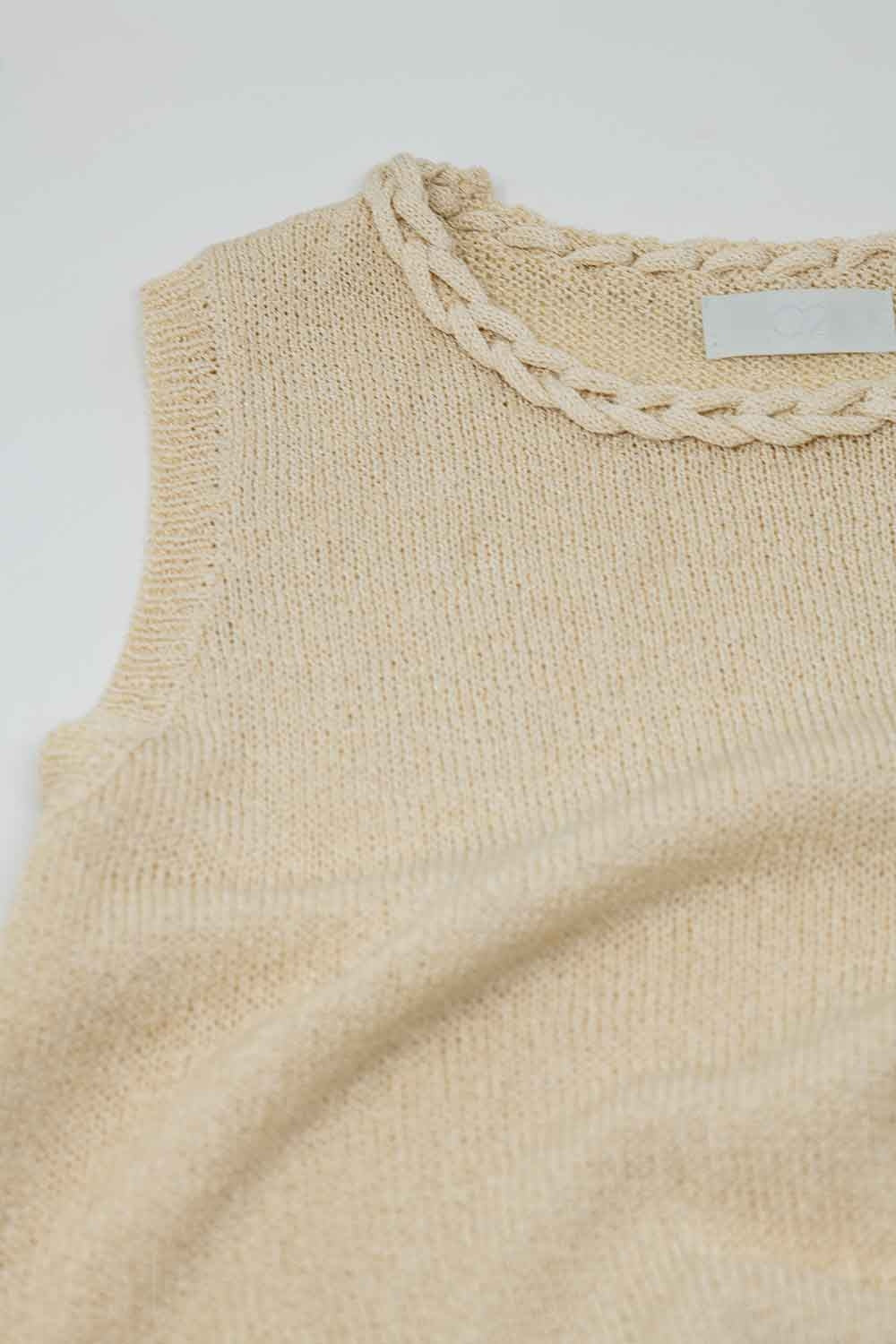 Pull beige sans manches avec encolure ras du cou et détails de tresses à l'encolure