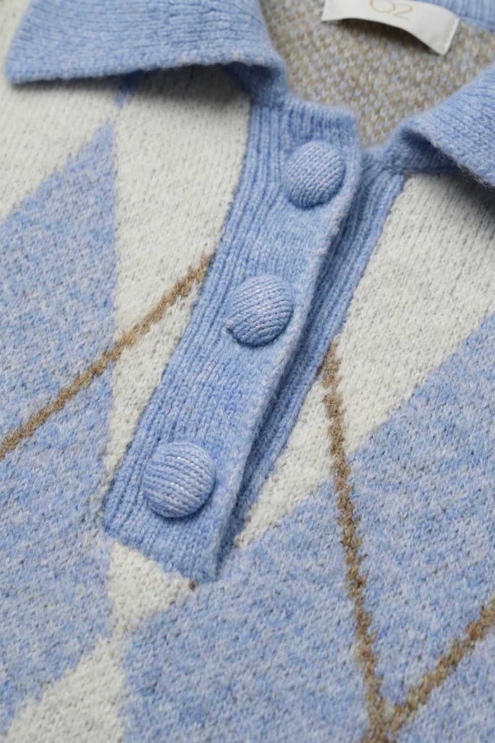 Pull en maille à motif losanges bleu à col polo